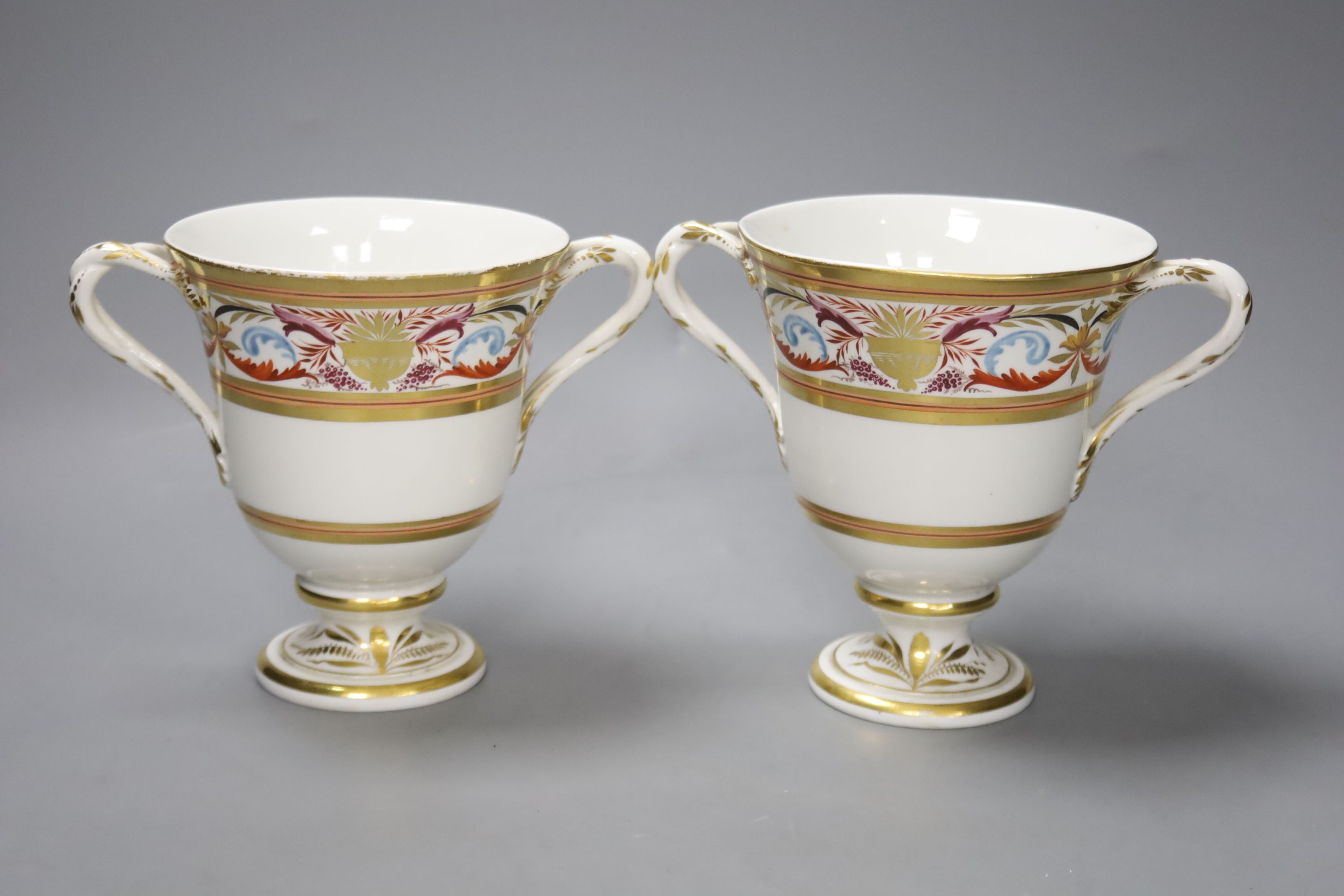 A pair of Derby two handled loving cups, c.1805, painted in arabesque style, pattern no.407, height 14cm